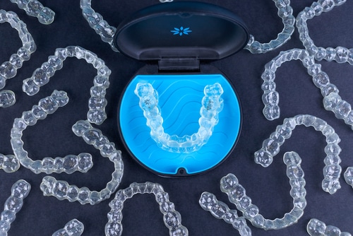 Plastic,Case,With,Invisible,Transparent,Orthodontic,Retainers,Invisalign,On,Black - Invisible Braces Invisalign Clear Aligners Orthodontists in Buffalo, NY